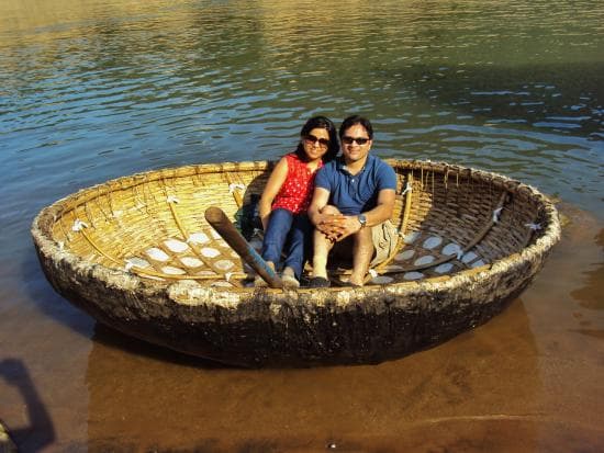 Family on a coracle ride at MangroveSpot, Nedungolam, Kollam — calm water, life jackets provided